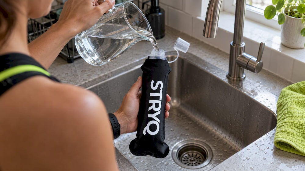 Runner pouring water into a black soft flask