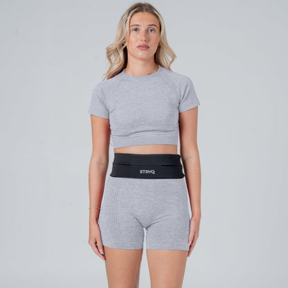Runner wearing a black running belt in photoshoot