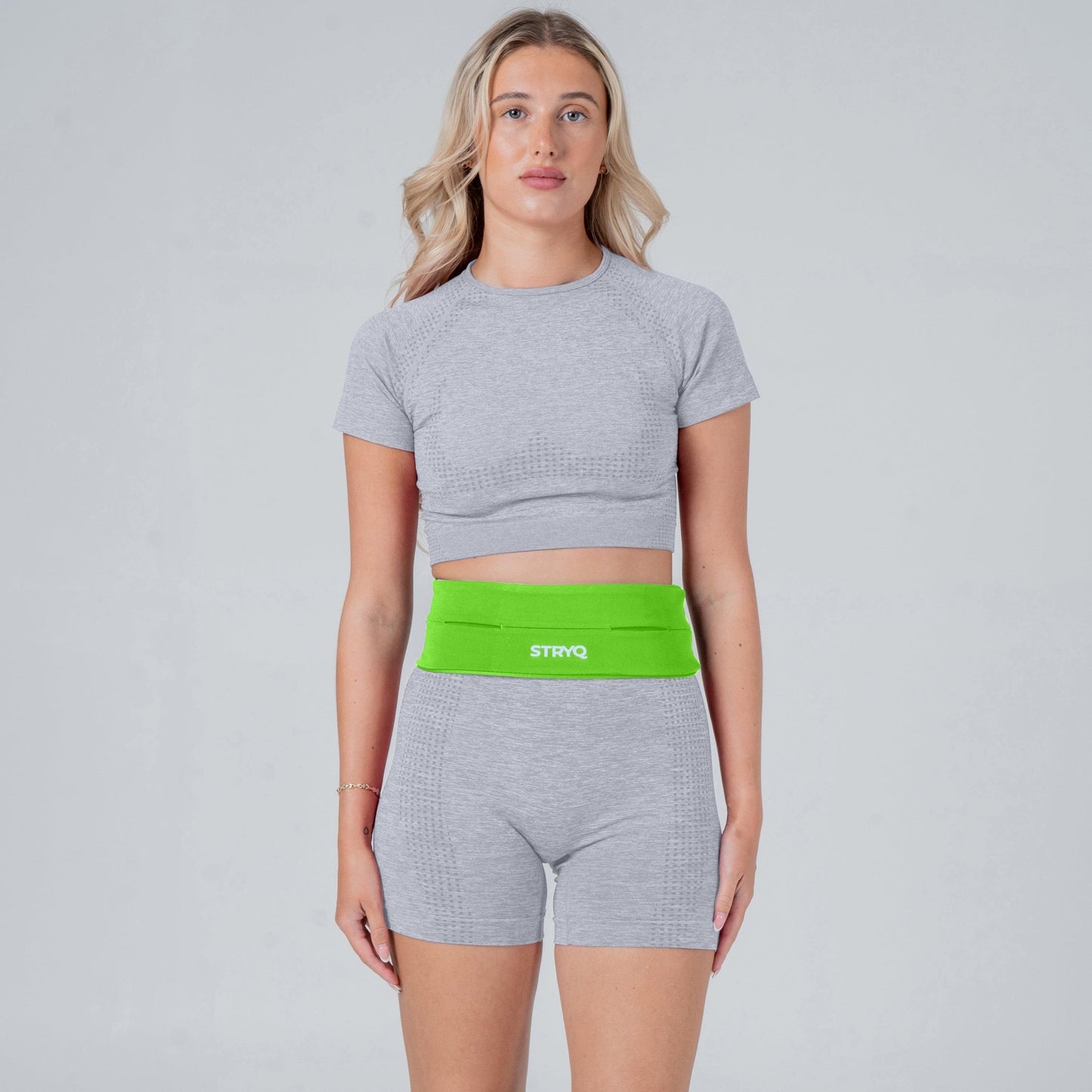 Runner wearing a green waist pack in photoshoot