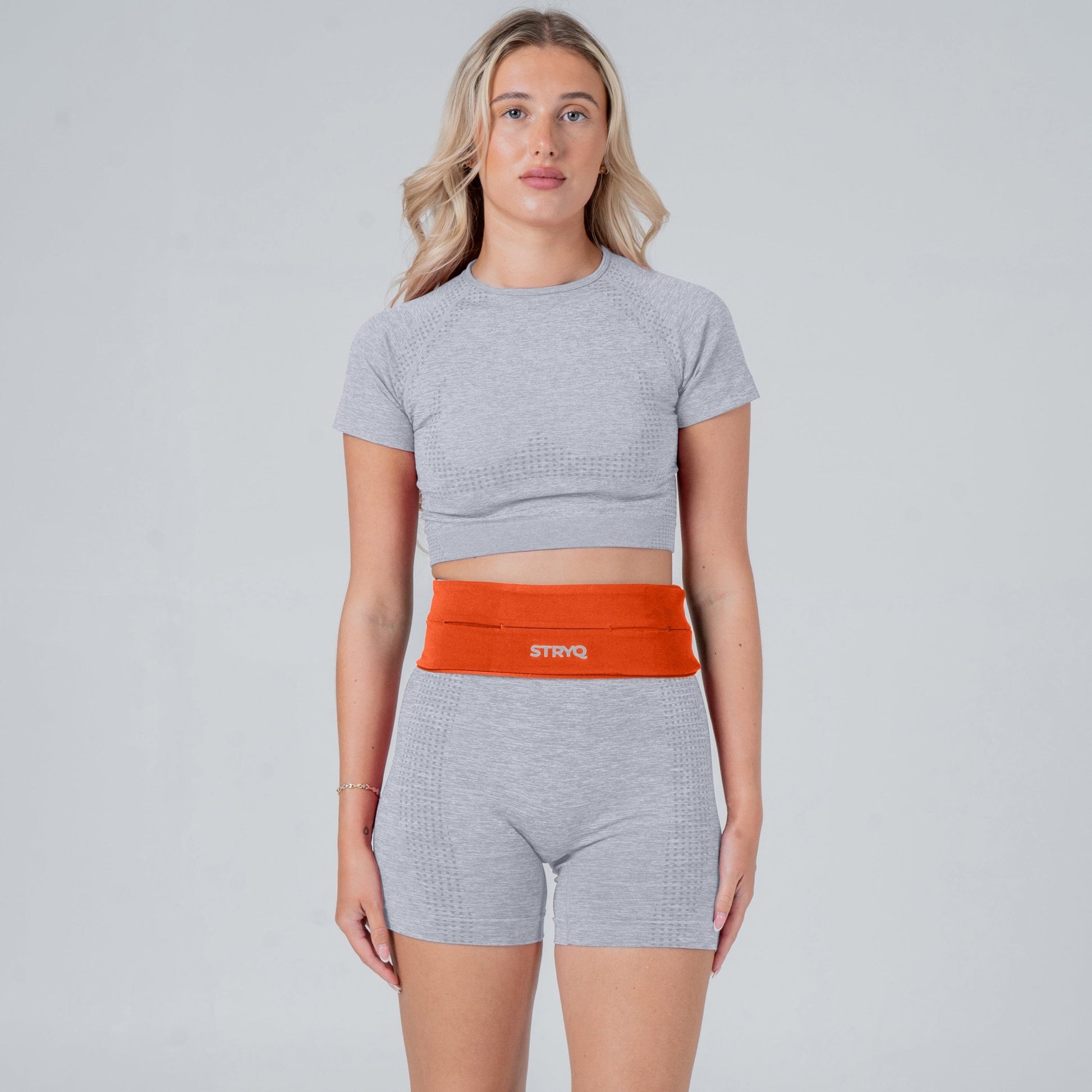 Runner wearing a orange running belt in photoshoot