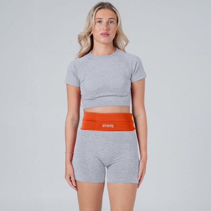 Runner wearing a orange running belt in photoshoot