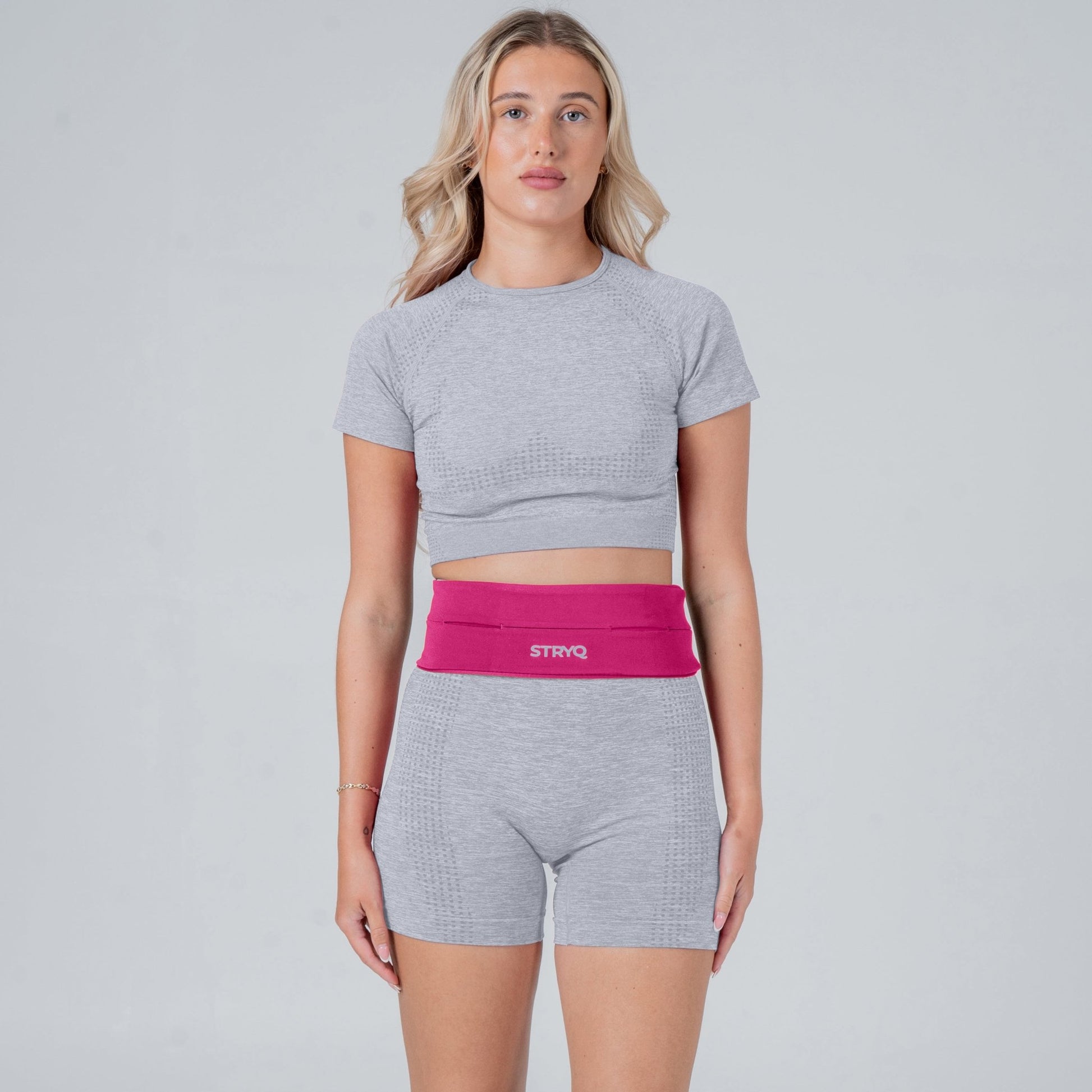 Runner wearing a pink waist pack in photoshoot