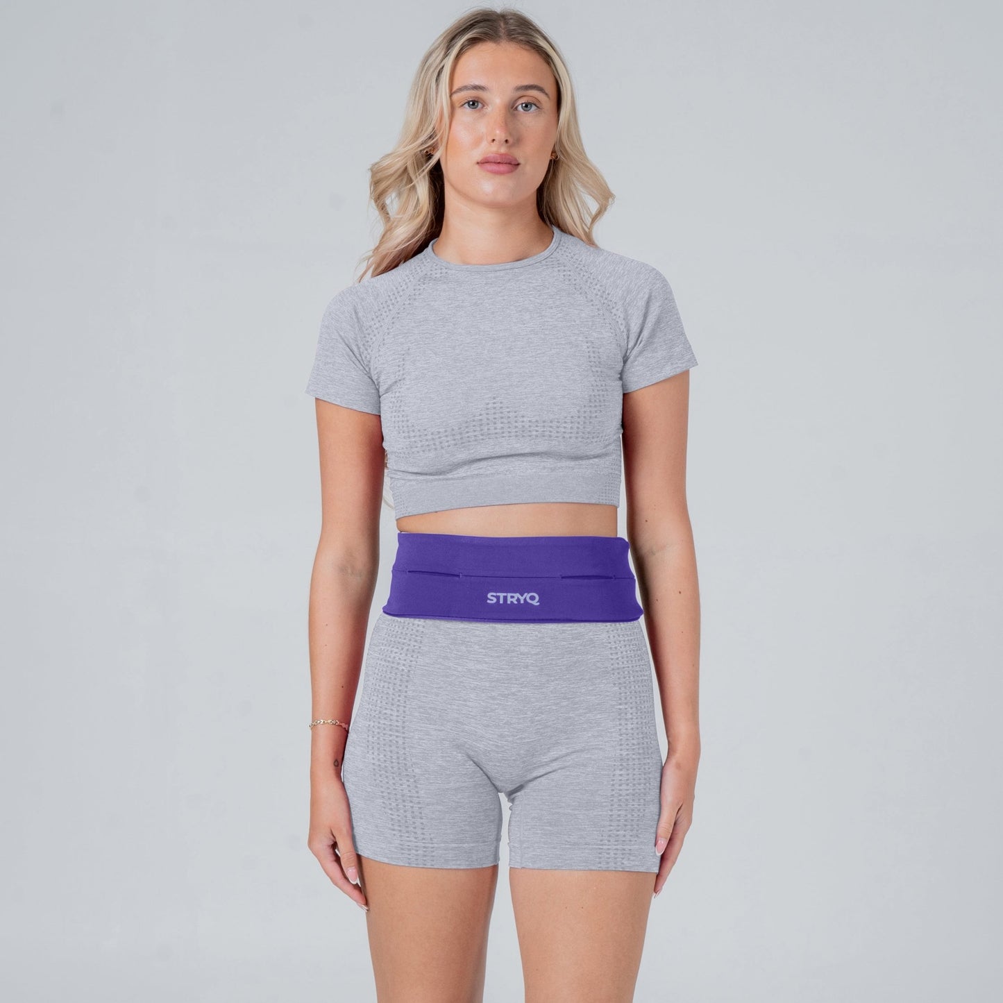 Runner wearing a purple running belt in photoshoot