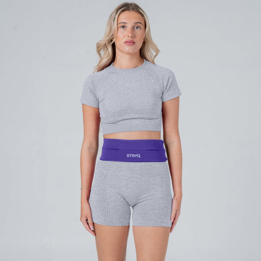 Runner wearing a purple running belt in photoshoot