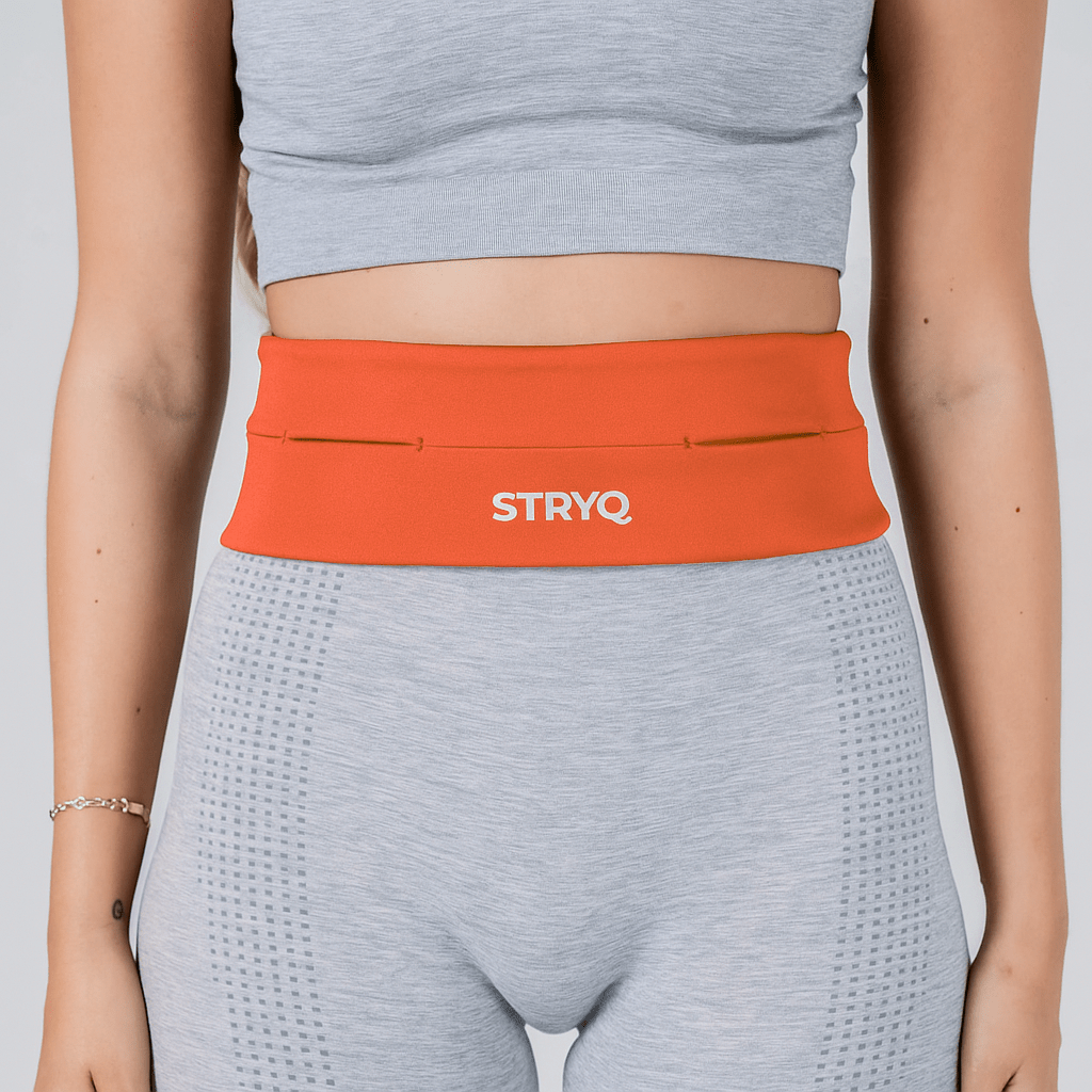 woman wearing STRYQ RUNNING BELT - ORANGE