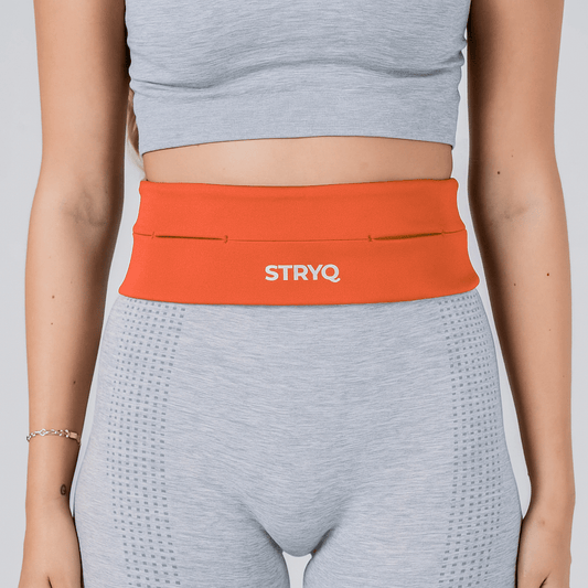 woman wearing STRYQ RUNNING BELT - ORANGE